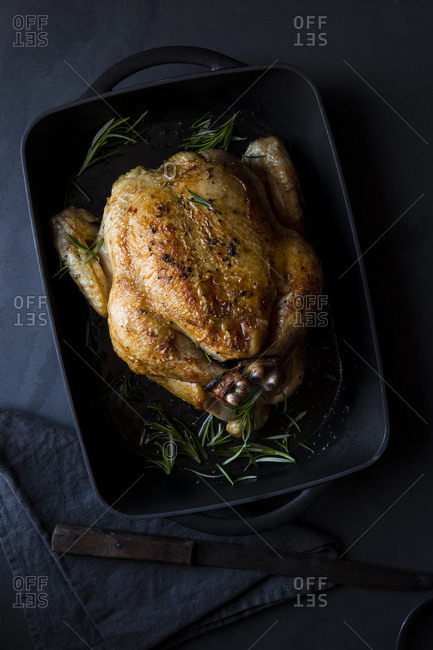 Whole roasted chicken in a cast iron pan
