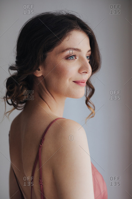 Portrait of beautiful tender young woman in silky nightgown.