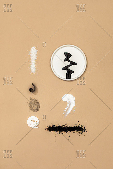 Minimalistic composition of natural cosmetic creams and scrubs on pastel background.