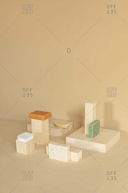 Minimalistic composition of natural soaps on wooden cubes.