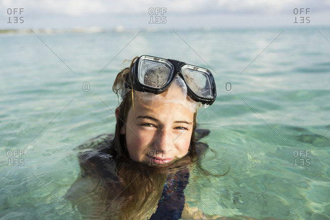 A teenage girl wearing snorkelling mask in the ocean