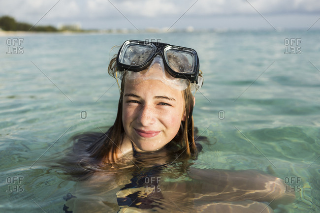A teenage girl wearing snorkelling mask in the ocean