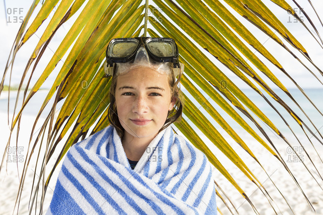 A teenage girl in front of palm fronds