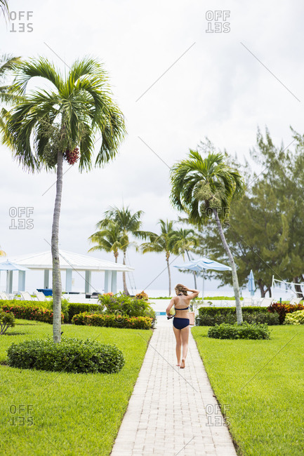 Rear view of a teenage girl walking to pool