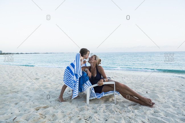 Mother and her 5 year old son kissing on the beach