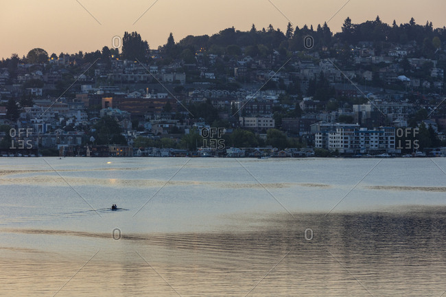Crew racers rowing double scull boat on Lake Union at dawn, Seattle, Washington, USA.