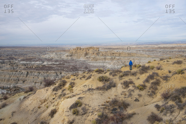 Hiker overlooking the Angel Peak Scenic Area in northwest New Mexico