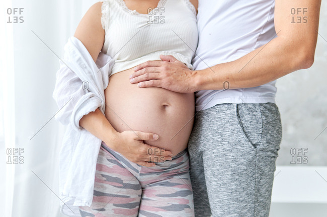 Pregnant belly. Husband and wife getting ready in the morning photo.