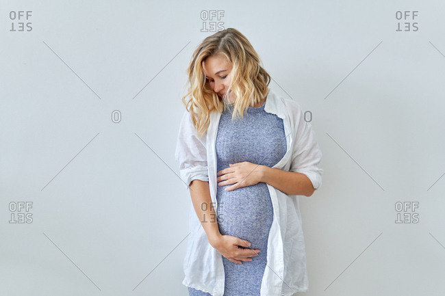 Portrait of a beautiful pregnant woman wearing a saree stock photo - OFFSET