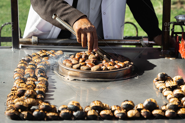 Man roasts chestnuts on the street