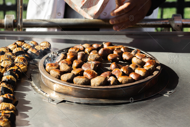 Close up of man roasting chestnuts on the street