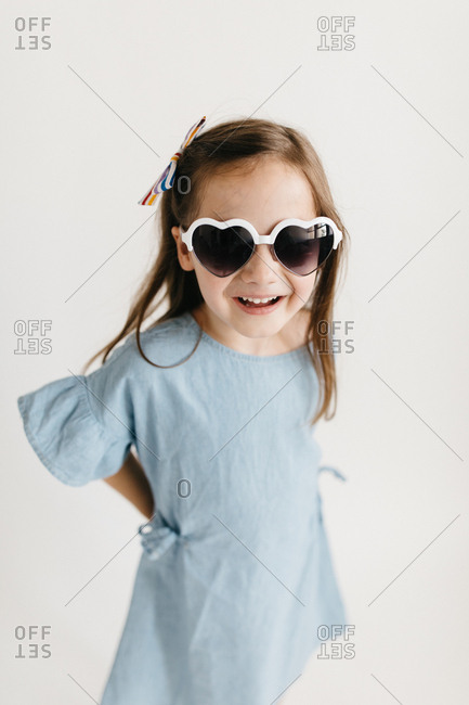 Little girl wearing aviator sunglasses stock photo - OFFSET