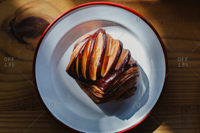 Detail of pain au chocolat sitting on a beautiful plate on a wooden table