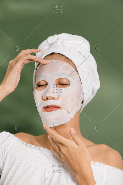 Woman puts on a sheet mask