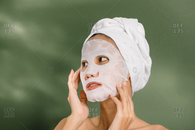 Pretty woman using a face mask