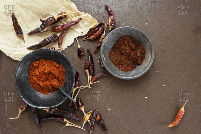 Japanese ceramic bowl with ground cayenne powder circled by dried peppers