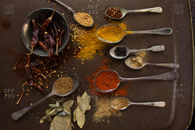 Creative composition of old spoons, herbs and spices