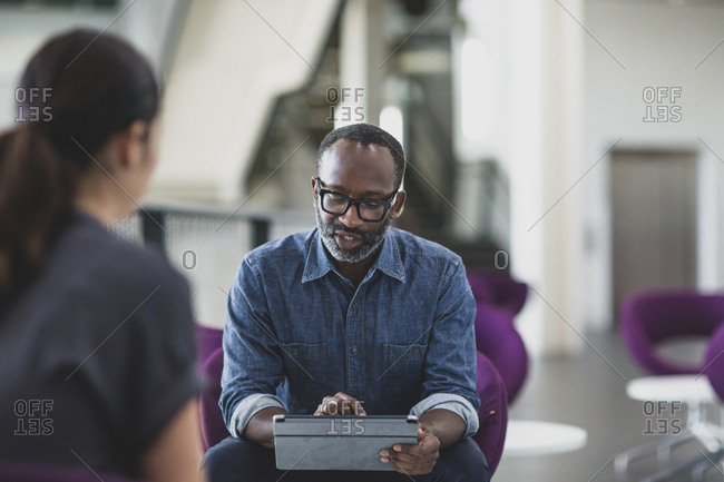 African American businessman using a digital tablet in a meeting