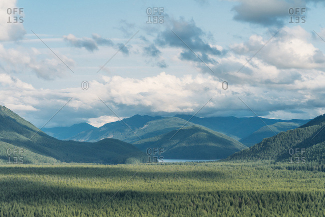 Hiking across green rolling hills with small lake in Washington