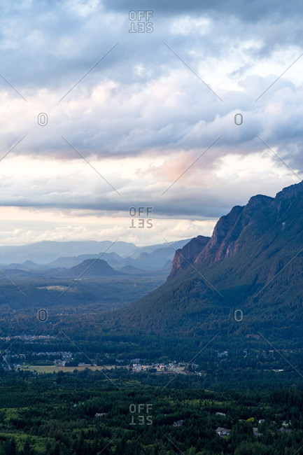 Cloudy summer sunset at Mt Si, Washington with small town at the base
