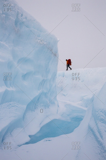 Hiker on adventure exploring the ice cap of Greenland