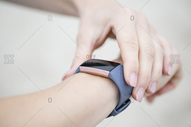 Close-up of woman checking her fitness tracker
