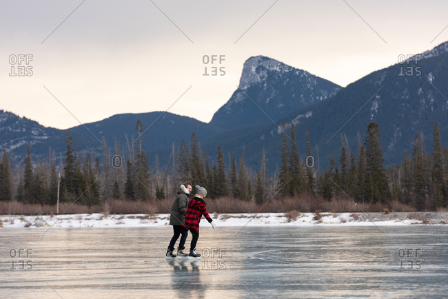 Couple skating together in snowy landscape