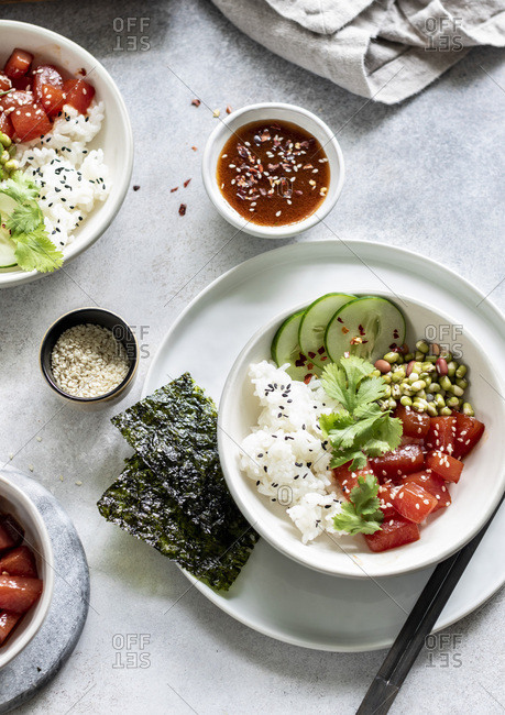Sauteed watermelon poke bowl served with rice, cucumbers, and sprouted adzuki, lentil and beans
