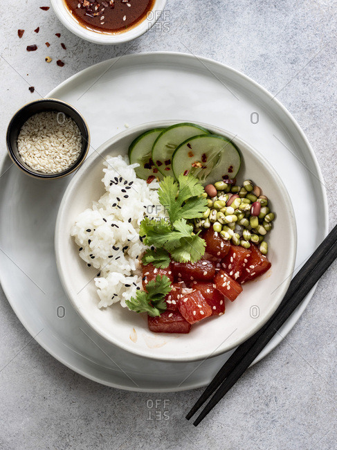 Sauteed watermelon poke bowl served with rice, cucumbers, and sprouted adzuki, lentil and beans
