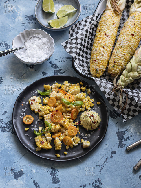 Shaved mexican street corn with herbed butter scoop on the plate.