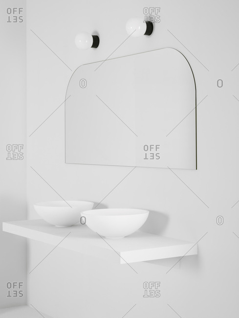 Ceramic bowl placed on simple shelf against white wall in bathroom with mirror