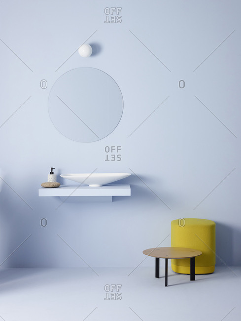Light bulb and oval mirror hanging on blue wall over sink in minimalist bathroom