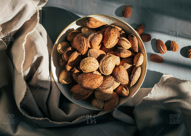 Bowl of almonds in shells on kitchen table
