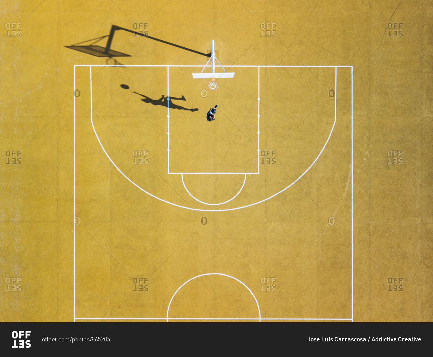 Young man playing basketball on outdoor court. Top view, bird eye view ...