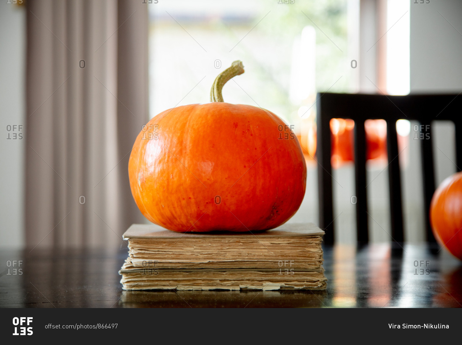 vintage books and pumpkin on a table