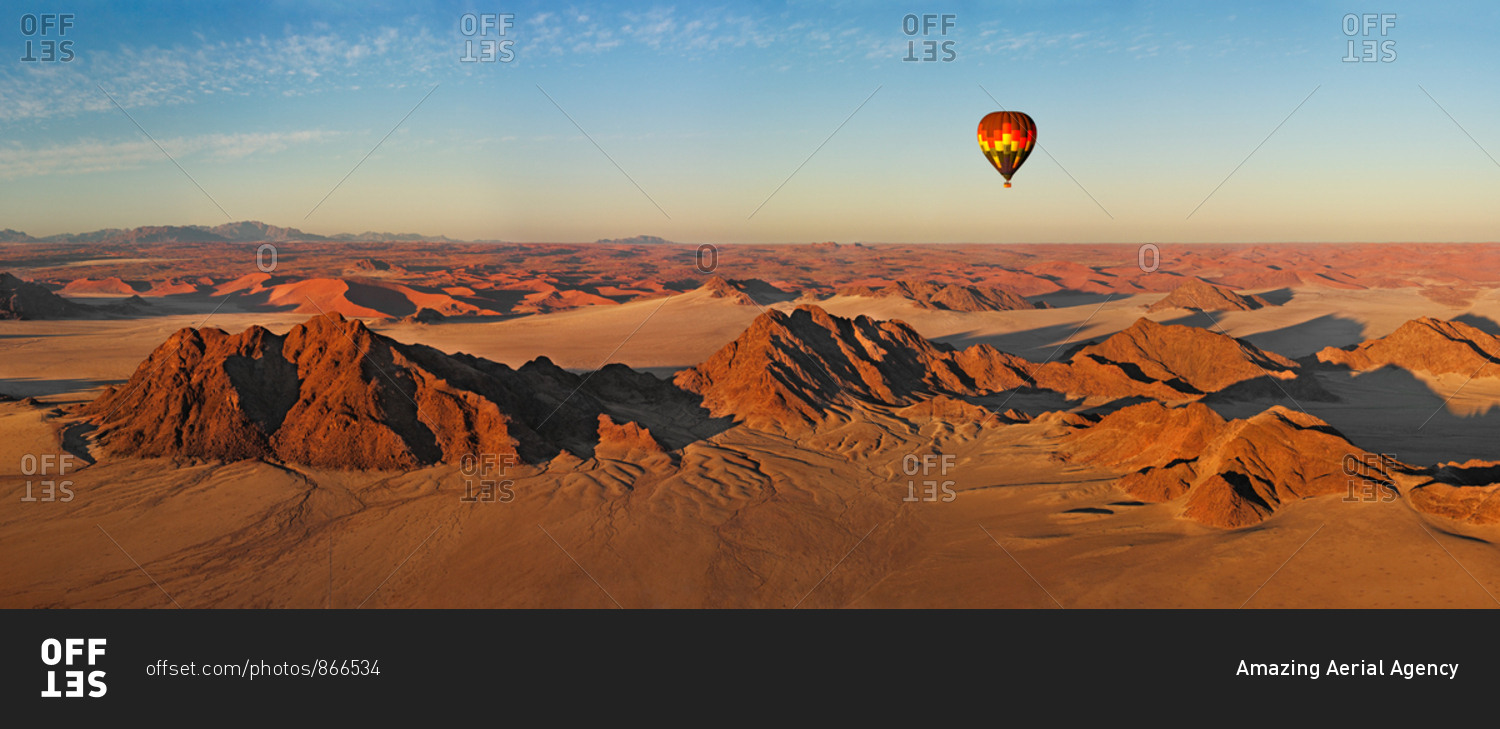 Aerial view of hot air balloon flying over Namibia desert.