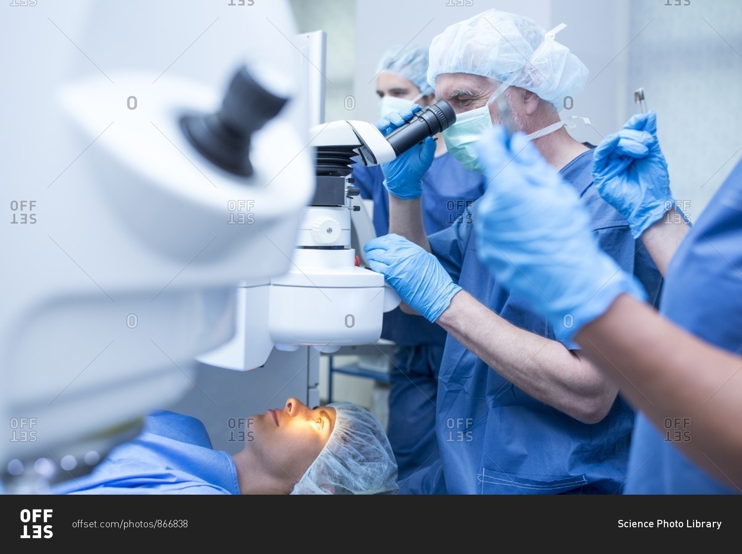 Surgical team performing laser eye surgery.