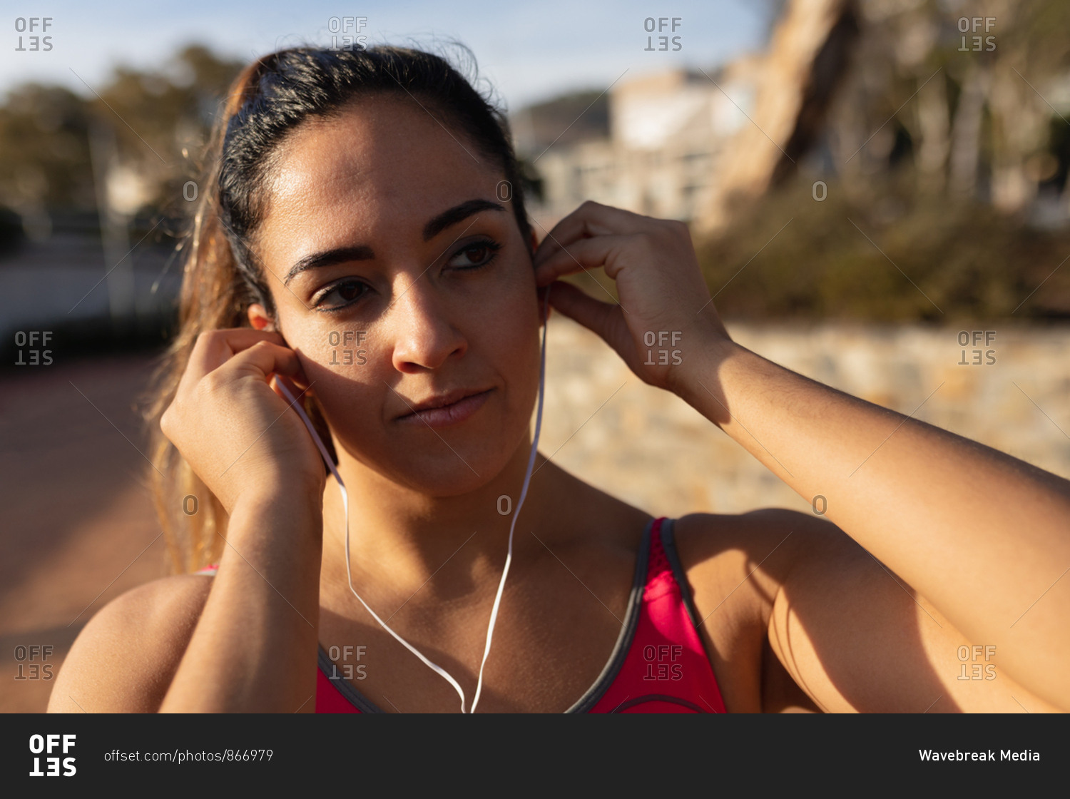 Woman listening to music and exercising in a park
