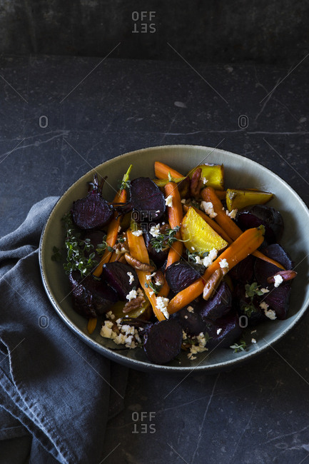 Bowl of roasted beetroot, carrot, cheese, and thyme