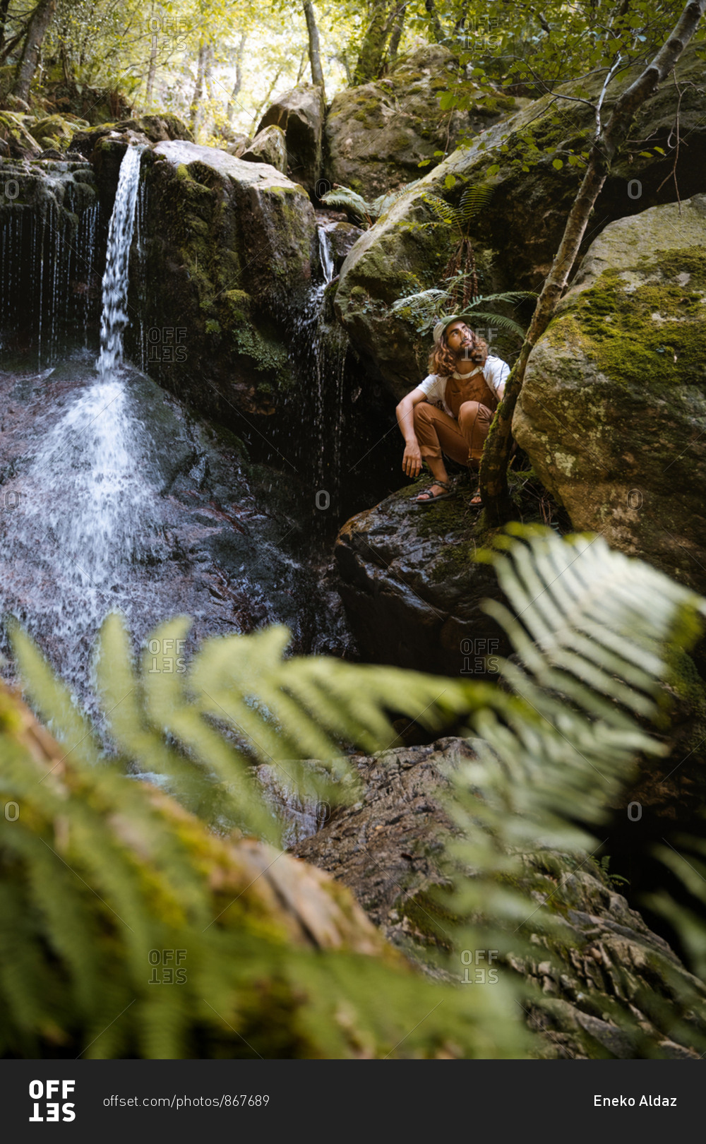 Young male hiker in sandals exploring hidden waterfalls