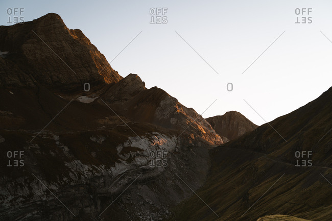 Sunset golden light hitting the hills of a big mountain in Pyrenees