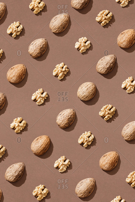 Pattern with walnuts on brown background