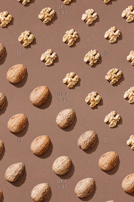 Pattern with walnuts on brown background
