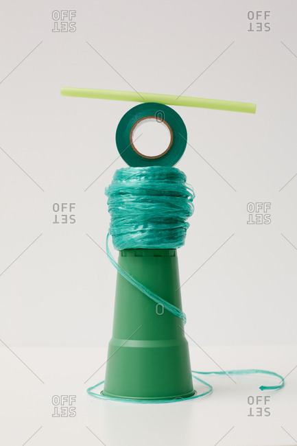 Emerald-green and green plastic objects balancing art installation