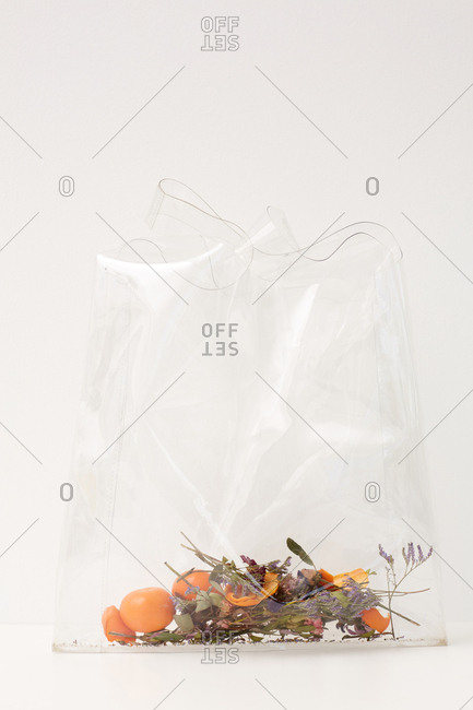 Fresh tangerines with leaves in a plastic bag Stock Photo