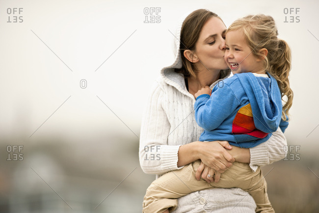 Happy mother holding her young daughter.