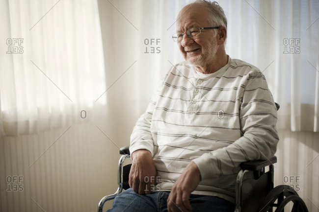 Laughing senior man sitting in a wheelchair.