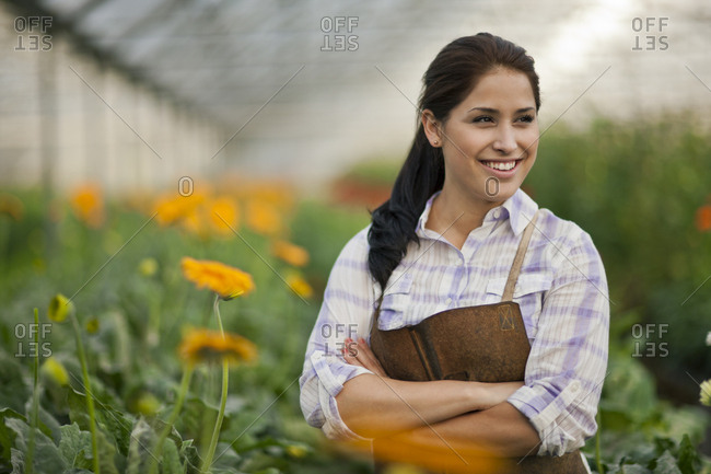 Teenage girl working in a greenhouse.