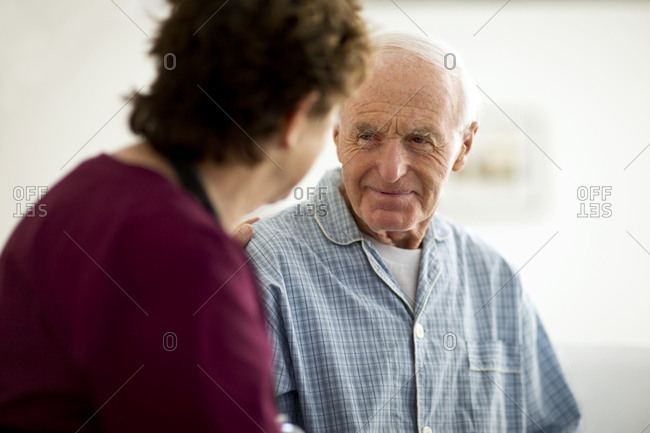 Thoughtful senior man listening to his nurse.