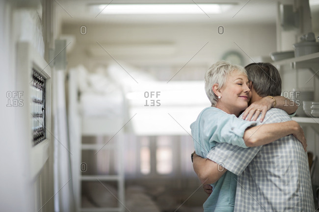 Affectionate mature couple share a tender embrace.